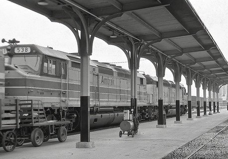 Contact us for a black and white photo of a train at a train station.