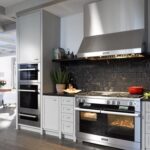 A kitchen with luxury stainless steel appliances such as a stove and oven.