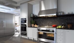 A kitchen with luxury stainless steel appliances such as a stove and oven.