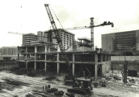 Contact us for an old photo of a construction site with cranes.