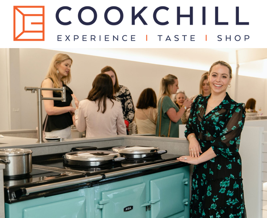 A woman standing in front of an oven with the words cook chill experience taste shop, surrounded by the best luxury kitchen appliances.